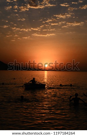 Beautiful blazing sunset landscape at Caspian Sea and orange sky above.