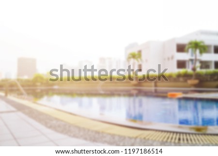 Blurred outdoor rooftop swimming pool.