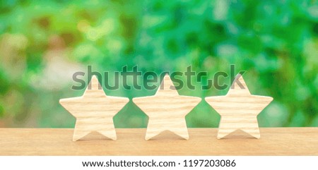 Three wooden stars. The rating of the hotel, restaurant, mobile application.The concept of rating and evaluation. Quality service, buyer choice. Success in business