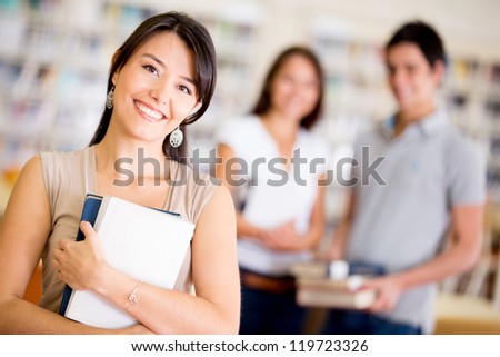 Group of college students at the library smiling