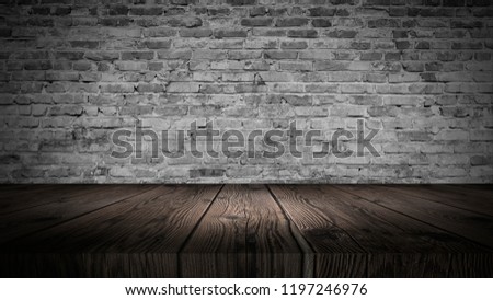 background of an empty white room, a cellar, lit by a searchlight. Brick white wall and wooden floor