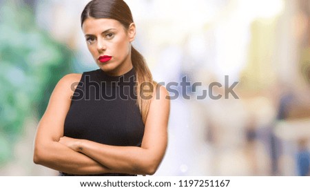 Young beautiful elegant business woman over isolated background skeptic and nervous, disapproving expression on face with crossed arms. Negative person.