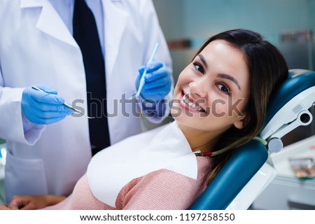 Her amazing smile! Beautiful young woman looking at camera with smile in dentist’s office
 Royalty-Free Stock Photo #1197258550