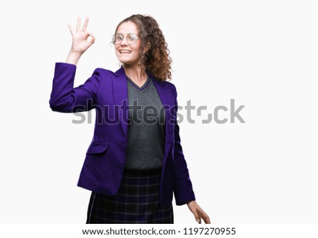 Young brunette student girl wearing school uniform and glasses over isolated background smiling positive doing ok sign with hand and fingers. Successful expression.