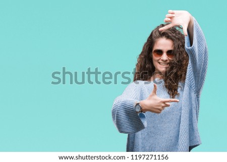 Beautiful brunette curly hair young girl wearing sunglasses over isolated background smiling making frame with hands and fingers with happy face. Creativity and photography concept.