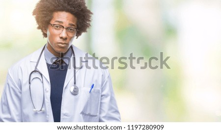Afro american doctor man over isolated background skeptic and nervous, frowning upset because of problem. Negative person.