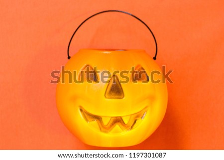 Happy Halloween with a fun and bright pumpkin. Orange background for Halloween cards. Trick or treat. Smiling pumpkin for banners and templates