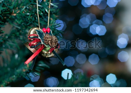 Christmas ornament, blurred christmas tree in the background, nalaline images.