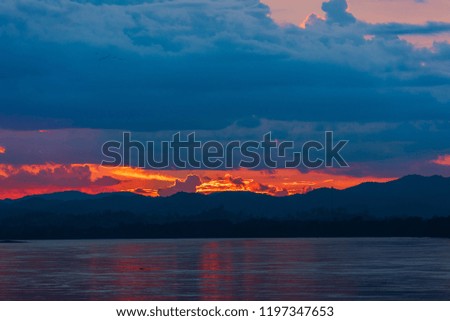 Beautiful sunset sky  with golden dramatic light over  mountain and river view.