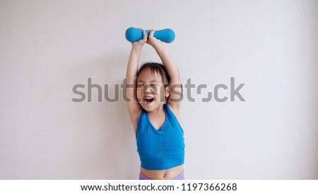 Kid girl holding blue dumbbell,exercises concept