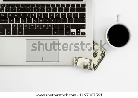 Metal notebook, a cup of black coffee and money on a white background. Working background. Top view