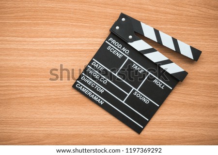 Cinema clapperboard on wooden background - Movie entertainment concept