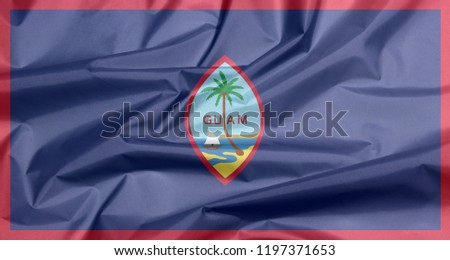 Fabric flag of Guam. Crease of Guam flag background, dark blue background with a thin red border and the Seal of Guam.