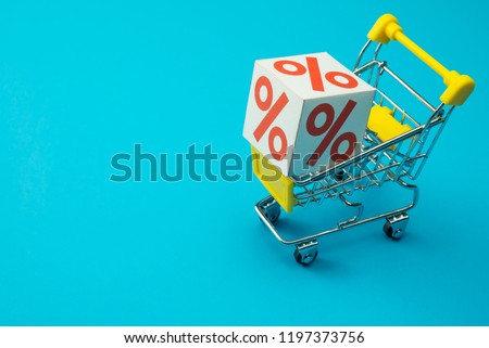 Shopping in department store, modern trade, hypermarket in lifestyle sale promotion season concept. Percentage(%) paper box in supermarket trolley on blue background. Shopaholic love 50% off promotion Royalty-Free Stock Photo #1197373756