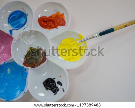focus on yellow on art color palatte with paintbrush Royalty-Free Stock Photo #1197389488