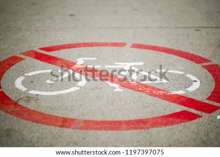 No bicycles sign on grey concrete.