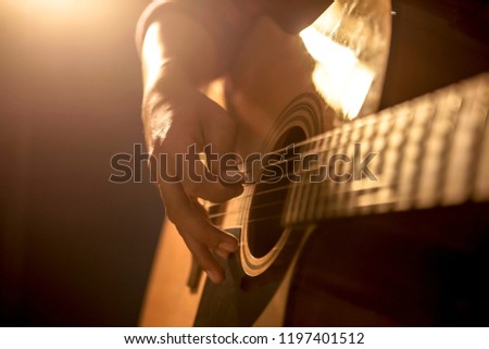 Man playing acoustic guitar Royalty-Free Stock Photo #1197401512