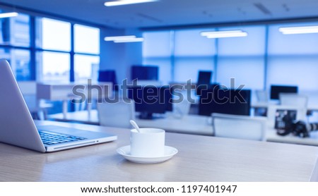 Modern style office interior with laptop and coffee