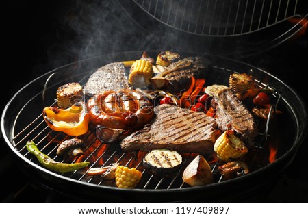 Assorted delicious meat and vegetables on barbecue grill