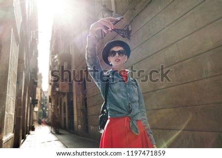 Tourism in Europe, Girl taking selfie self-portrait on smartphone on the street