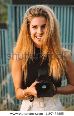 Beautiful woman using medium format camera in outdoor