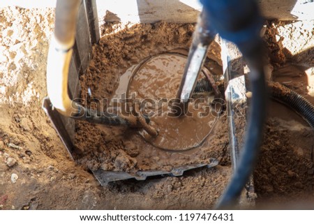 Machine for drilling a hole in the ground