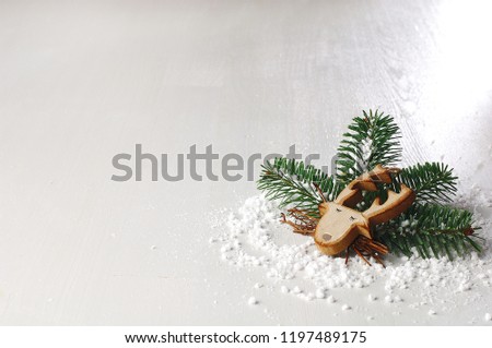 Christmas decoration pine tree and wooden deer, snow around, white background, space for text