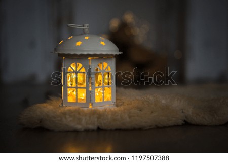 Christmas and new year interior, decorations in the form of houses with garland. Cozy garlands and Windows of the house decorate the room, Shine with Golden light