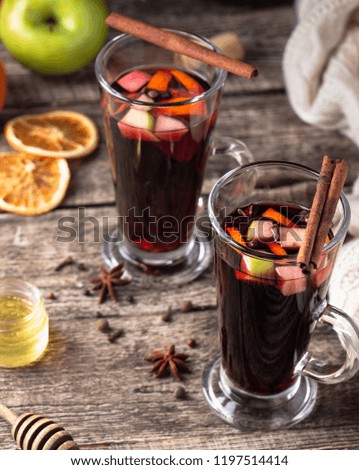 Hot drink. Mulled wine with apples, oranges and spices.