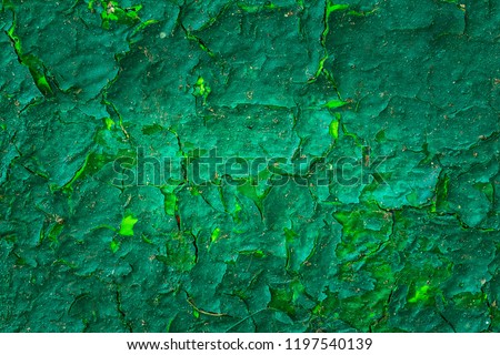 fantastic green texture of cracked paint covering a metal surface grunge background for design