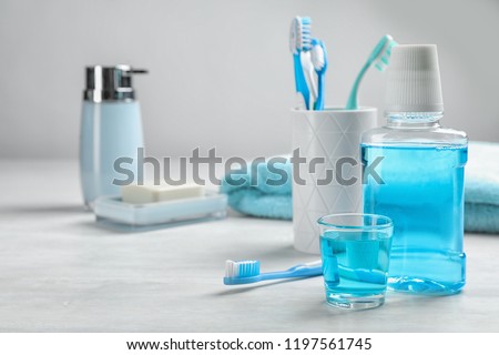 Set of oral care products on light table. Teeth hygiene Royalty-Free Stock Photo #1197561745