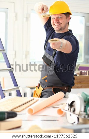 Arm of smiling worker hold brush portrait. Manual job workplace DIY inspiration improvement fix shop yellow helmet hard hat joinery startup idea industrial education profession career concept