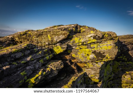 Big rock with yellow lichen on peak of Velky Keprnik with dark blue sky in Jeseniky Czech Republic Royalty-Free Stock Photo #1197564067
