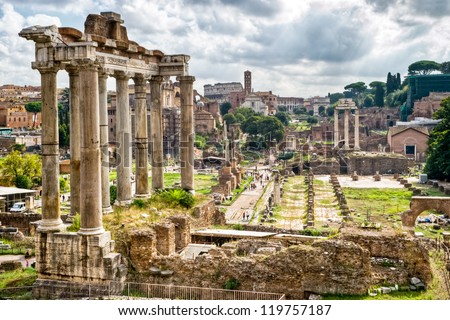 Roman Forum in Rome, Italy. It is tourist attraction of Roma. Panorama of great remains of Roma Empire. View of Temple of Saturn and Via Sacra, Ancient ruins of Roma city in summer. Rome cityscape.
