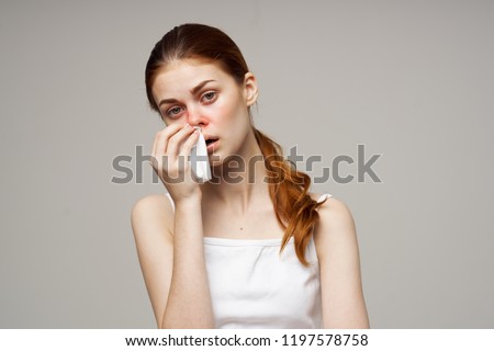 sick woman wipes a red nose with a handkerchief                         Royalty-Free Stock Photo #1197578758