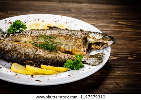 Fish dish - fried fish on wooden table