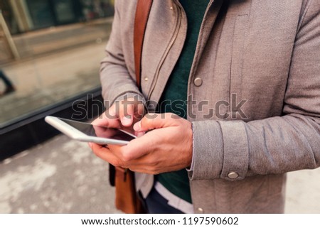 Cropped shot of businessman using smartphone