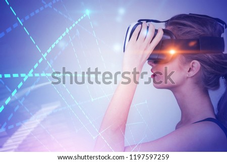 Side view of young woman with long fair hair wearing tank top and vr glasses looking at diagrams and graphs over white background. Toned image double exposure