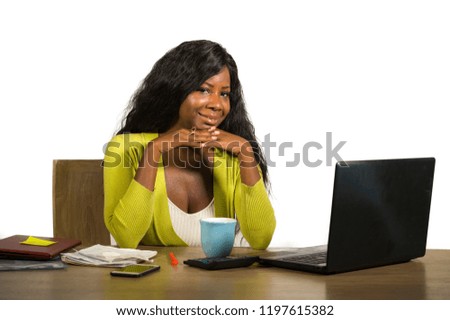 young happy and attractive black Afro American business woman smiling cheerful and confident working at office computer desk relaxed in successful businesswoman and job success concept