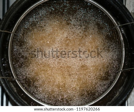 fryer filled with boiling oil Royalty-Free Stock Photo #1197620266