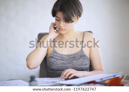 adult girl draws on paper pencils / portrait of a beautiful young female student, art school education, concept of art education