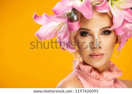 Beautiful blonde smiling woman with a lily