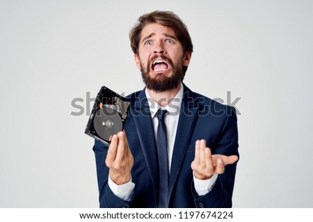 frustrated man with a hard disk in his hand                       