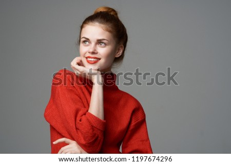 smiling woman in red sweater                         