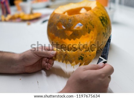 Man making halloween pumpkin