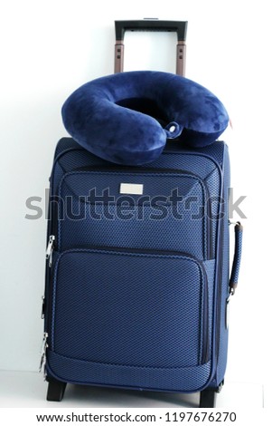 Traveling suitcase with blue travel pillow, vacation summer concept.
 Royalty-Free Stock Photo #1197676270
