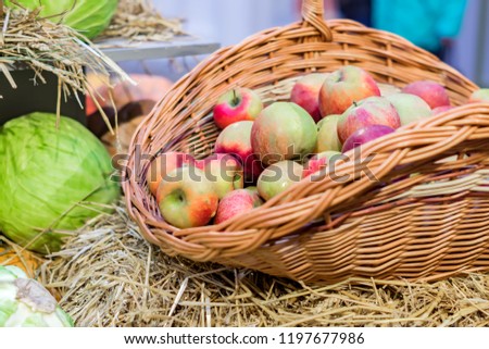 close up of red ripe apples in a basket at the farmer's market