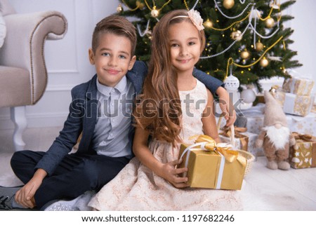 Happy little couple with gifts, christmas evening day