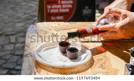 Ginja de Obidos, traditional sour cherry liquor, served in small cups made of chocolate Royalty-Free Stock Photo #1197693484