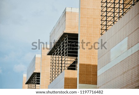 Yellowish modern architectural building isolated unique photo